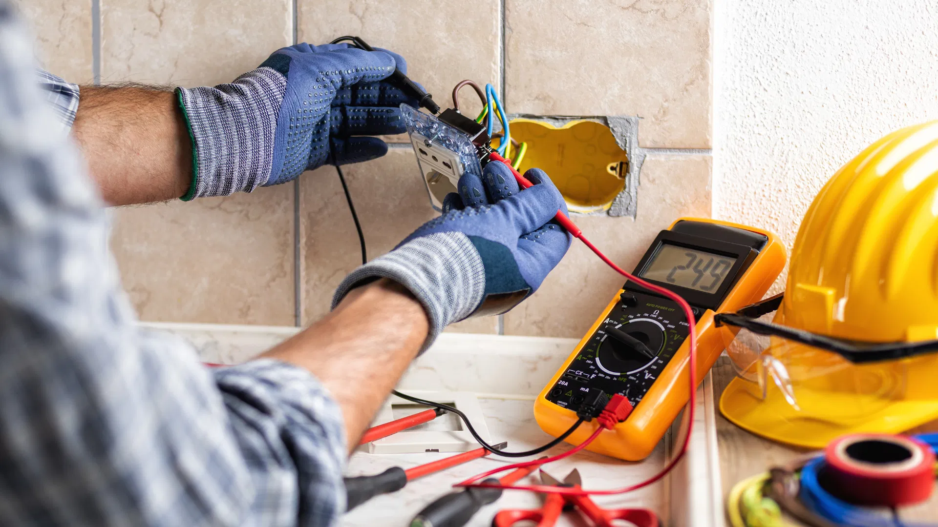 A licensed electrician testing voltage and wiring during a residential installation.